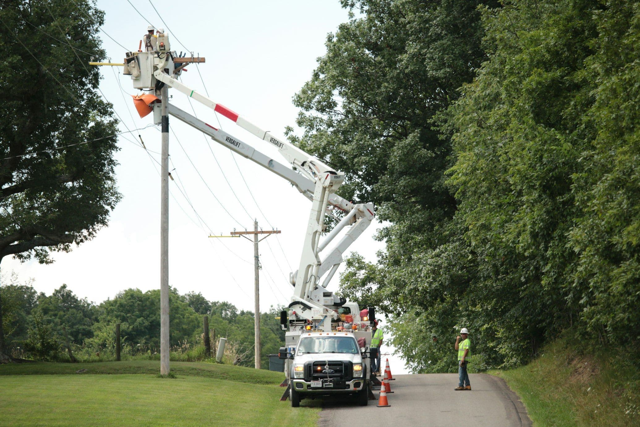 Mobile crane with telescopic boom lifting materials at a building site