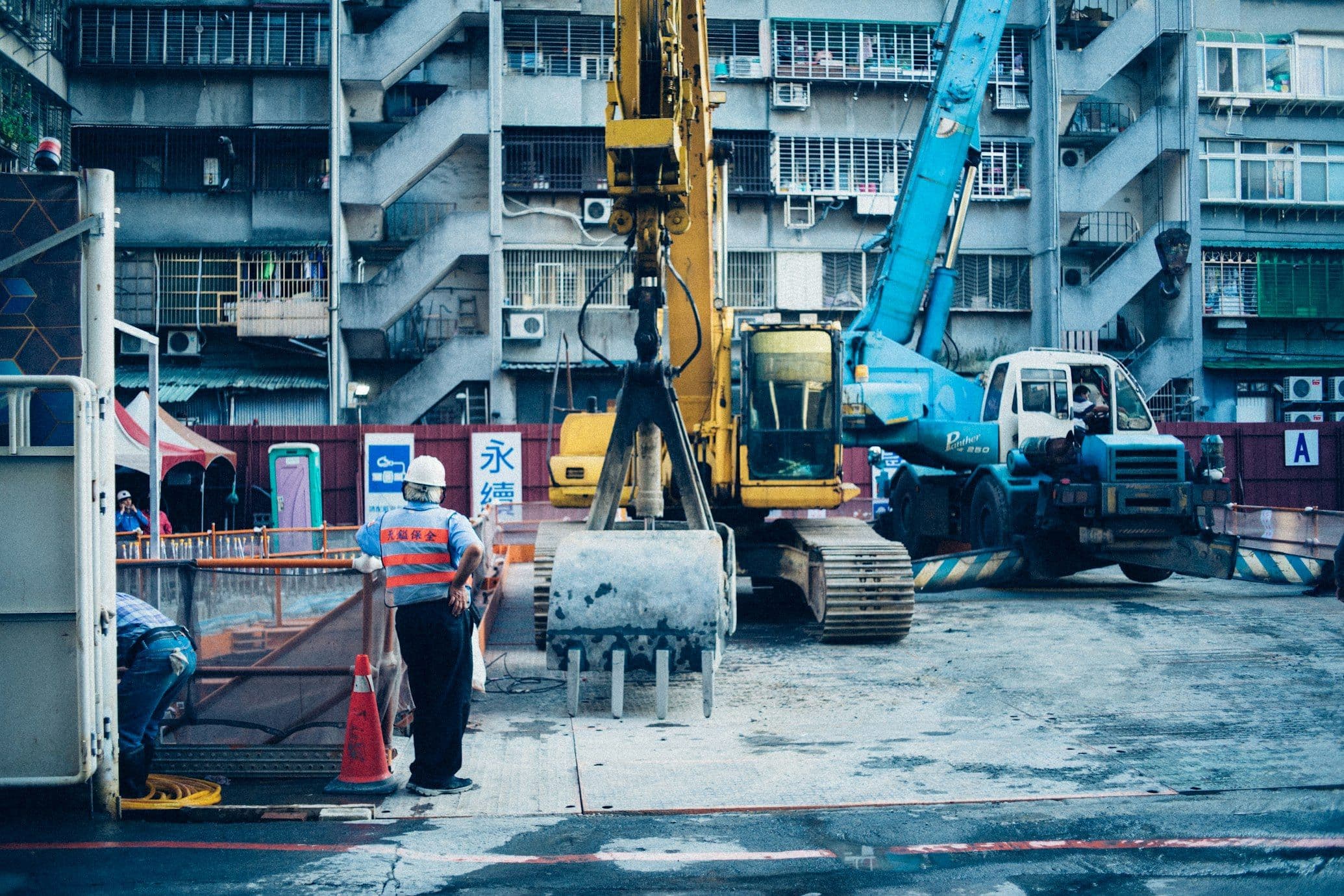 Yellow backhoe loader working on a construction site